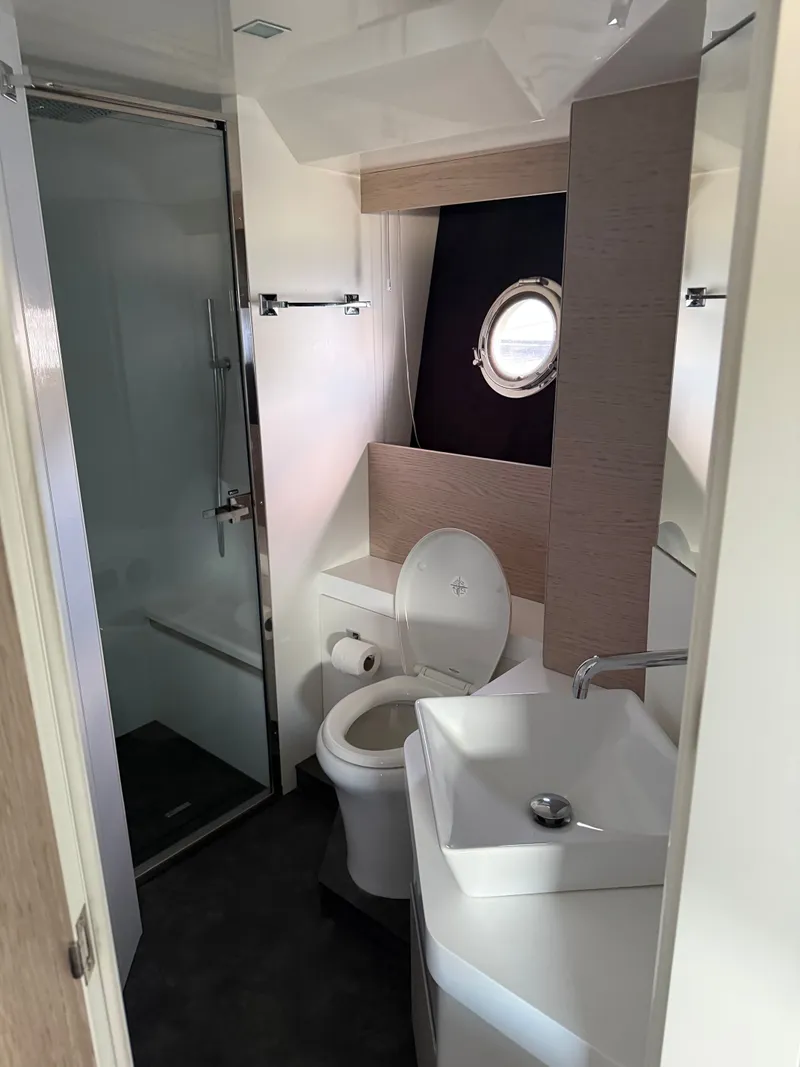 Slide: The Image of The bathroom of a 2019 Cranchi E 52S Evoluzione with a shower, toilet, and sink. - 47