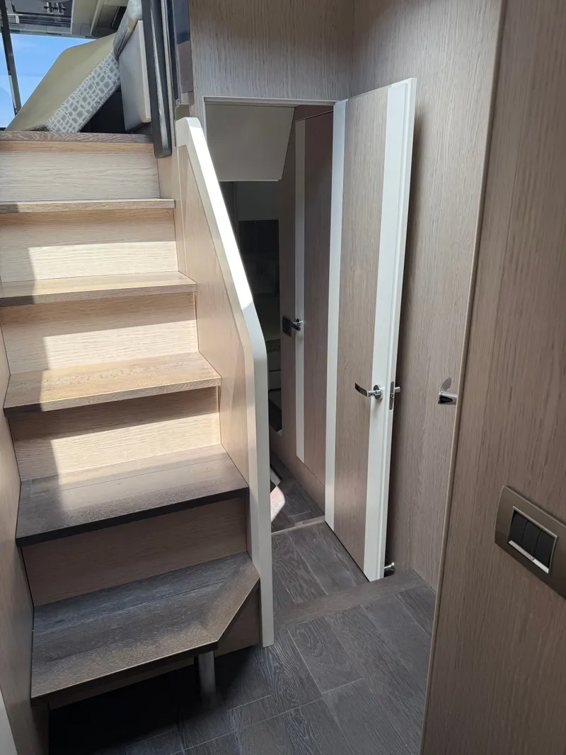 Slide: The Image of Interior of the 2019 Cranchi E 52S Evoluzione with wooden stairs and a door. - 41