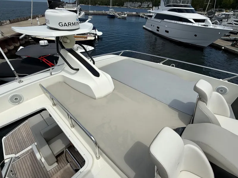Slide: The Image of The image shows the deck of a 2019 Cranchi E 52S Evoluzione at a marina. - 22