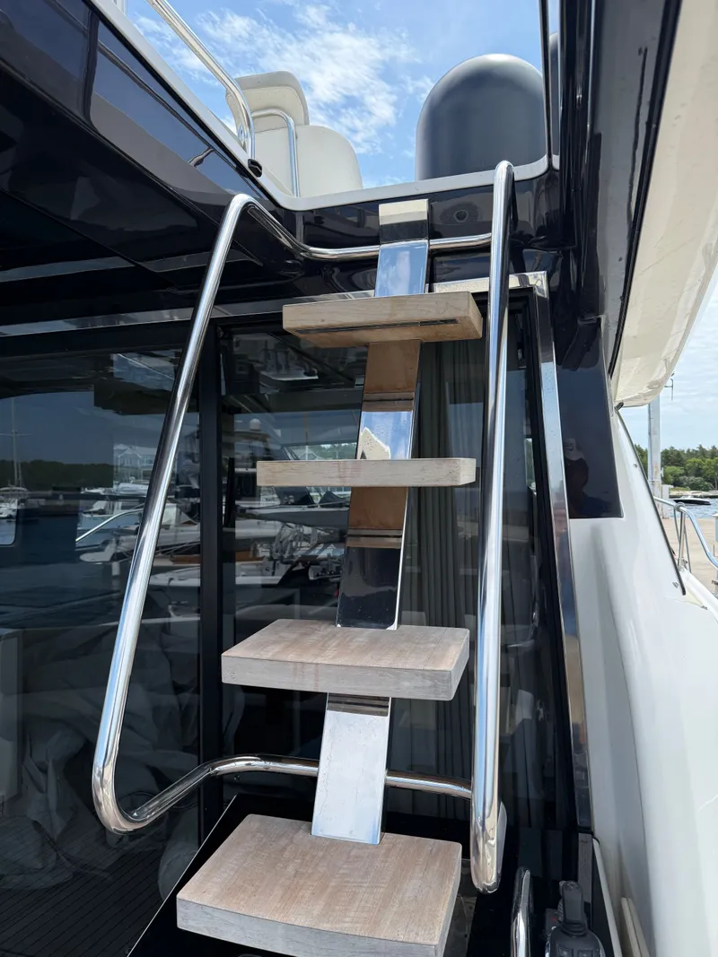 Slide: The Image of A modern staircase with wooden steps and metal railing on a yacht. - 21