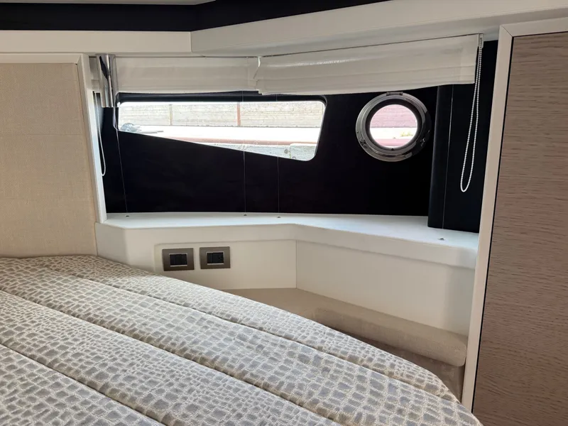Slide: The Image of The cabin of a 2019 Cranchi E 52S Evoluzione with a bed and a porthole. - 45