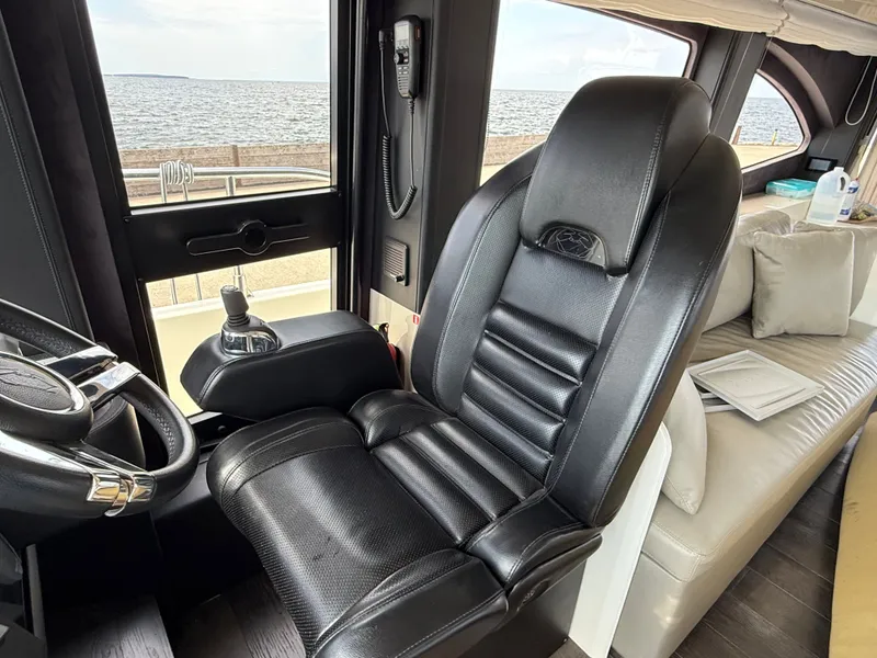 Slide: The Image of The interior of a 2019 Cranchi E 52S Evoluzione features a luxurious black leather seat. - 37