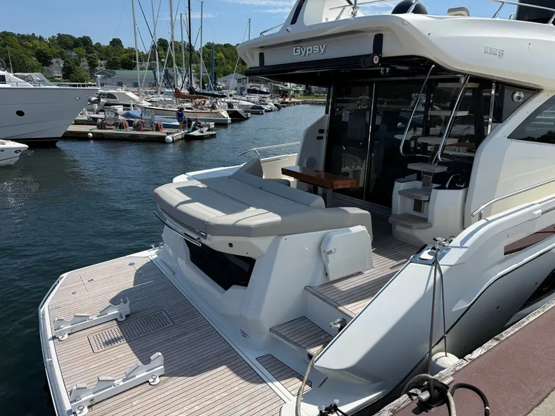 Slide: The Image of The 2019 Cranchi E 52S Evoluzione is docked at a marina, featuring a spacious aft deck. - 5