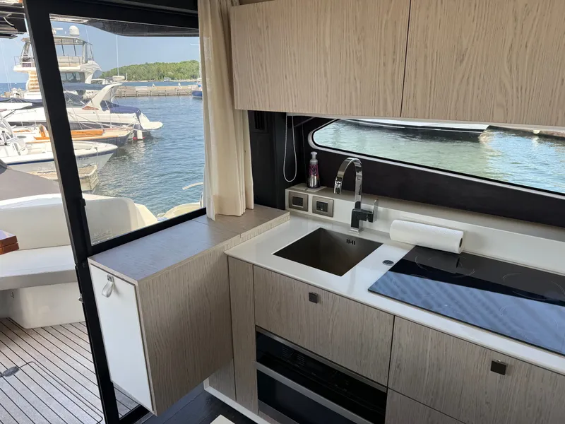 Slide: The Image of The 2019 Cranchi E 52S Evoluzione features a modern kitchen overlooking the marina. - 29