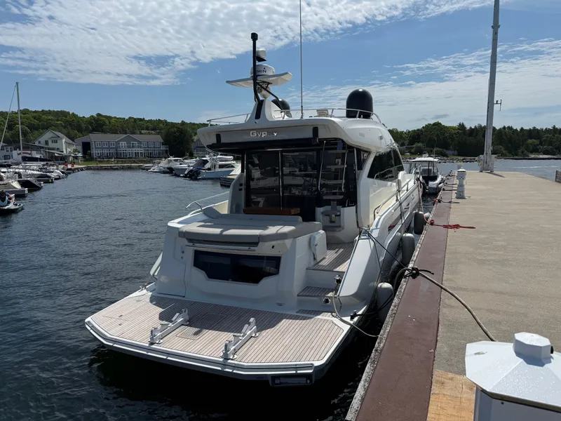 Slide: The Image of A 2019 Cranchi E 52S Evoluzione docked. It features a sleek design and spacious aft platform. - 4
