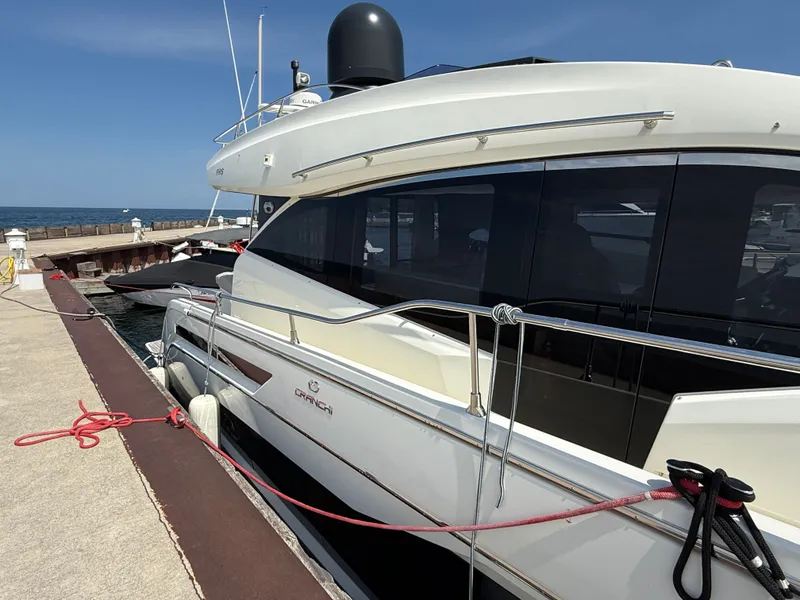 Slide: The Image of The 2019 Cranchi E 52S Evoluzione is docked. It features a sleek, modern design. - 6