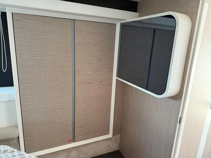 Slide: The Image of A sleek interior featuring a modern cabinet and a wall-mounted flat-screen TV. - 46
