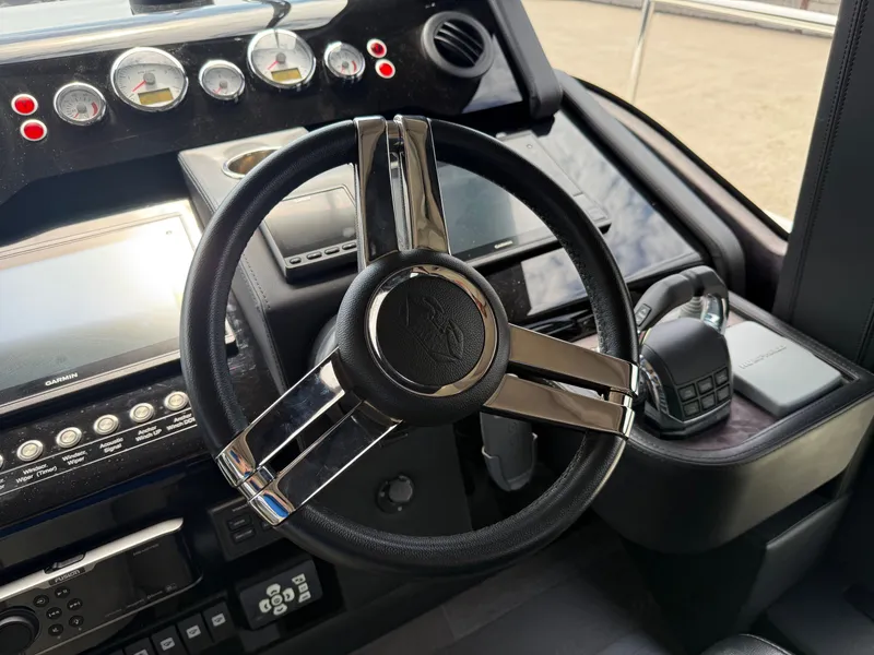 Slide: The Image of The image shows the cockpit of a 2019 Cranchi E 52S Evoluzione with a sleek steering wheel and modern instruments. - 36