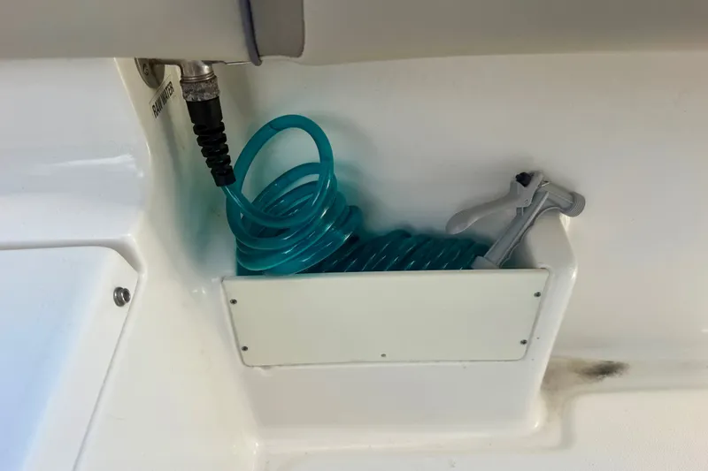 Slide: The Image of Coiled blue hose in 2023 Key West 239 FS boat compartment. - 22