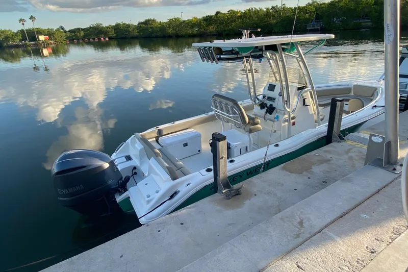 The Image of 2023 Key West 239 FS boat docked by calm waters, featuring Yamaha engine. - 4