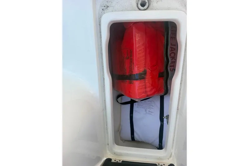 Slide: The Image of Storage compartment with life jackets on a 2023 Key West 239 FS boat. - 21