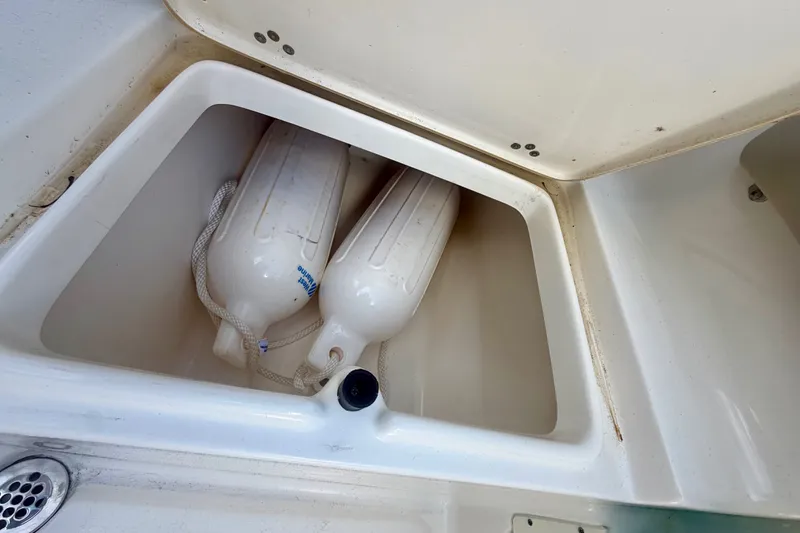 Slide: The Image of Storage compartment with fenders on a 2023 Key West 239 FS boat. - 20