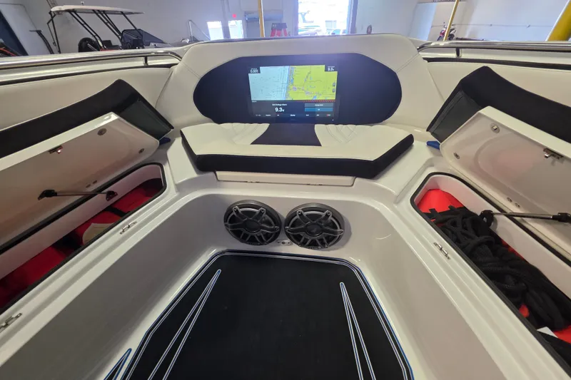 Slide: The Image of Interior of a 2021 MTI 42 v boat featuring a navigation screen and storage compartments. - 14