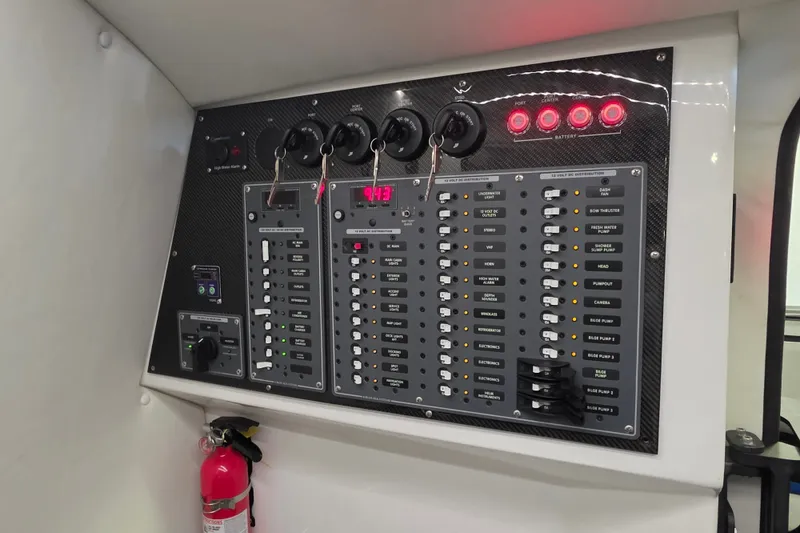 Slide: The Image of Control panel of a 2021 MTI 42 v boat with switches and fire extinguisher. - 20
