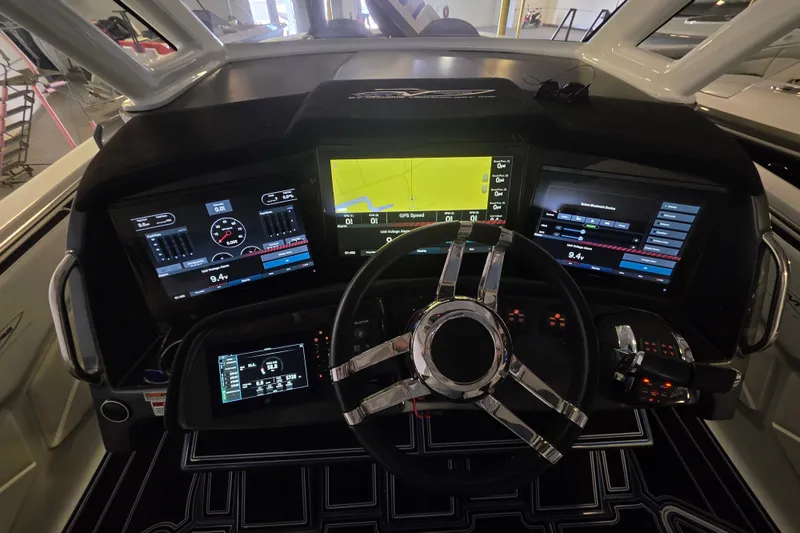 Slide: The Image of Cockpit of 2021 MTI 42 v boat with advanced navigation displays and controls. - 2