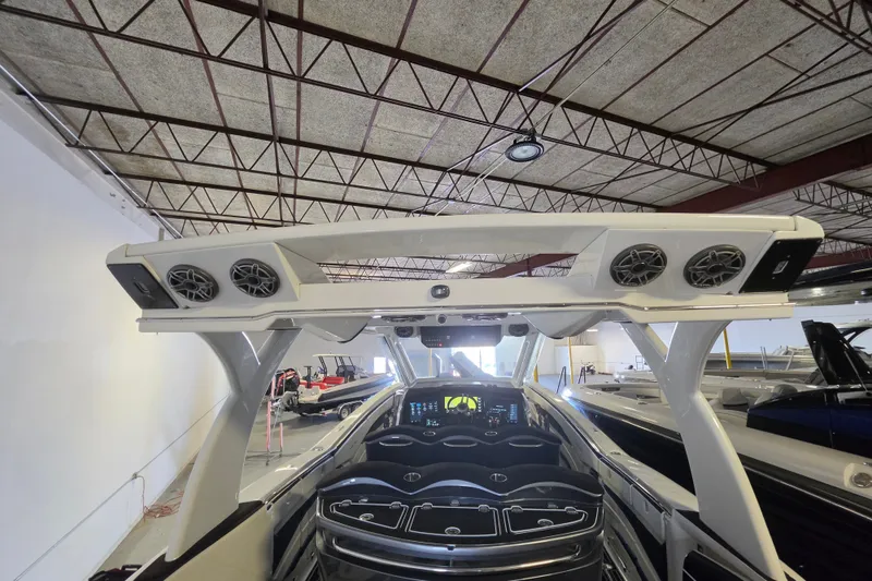 Slide: The Image of 2021 MTI 42 v boat interior with advanced dashboard and speaker system in a showroom. - 6