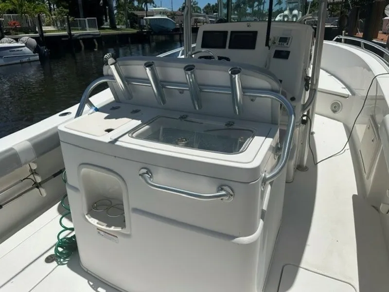 Slide: The Image of The image shows the cockpit of a 2018 Mako 284 boat with fishing rod holders. - 3