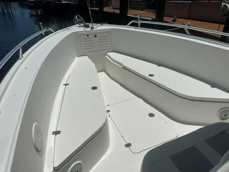 Slide: The Image of The image shows the bow area of a 2018 Mako 284 boat with white seating. - 10