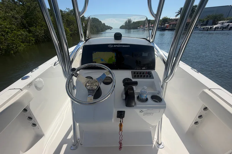 Slide: The Image of 2013 Sportsman Heritage 229 Center Console boat interior with steering wheel and navigation system. - 11
