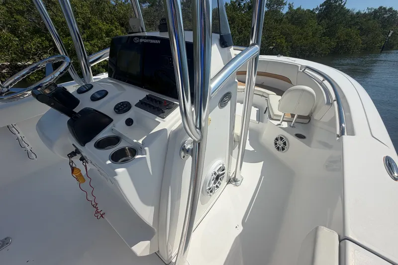 Slide: The Image of 2013 Sportsman Heritage 229 Center Console boat interior with steering wheel and seating. - 14