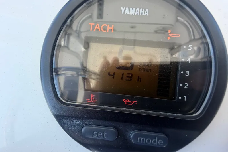Slide: The Image of Yamaha tachometer displaying 413 hours on a 2013 Sportsman Heritage 229 Center Console boat. - 25