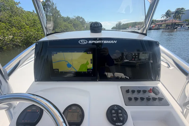 Slide: The Image of Center console of 2013 Sportsman Heritage 229 boat with navigation display. - 13