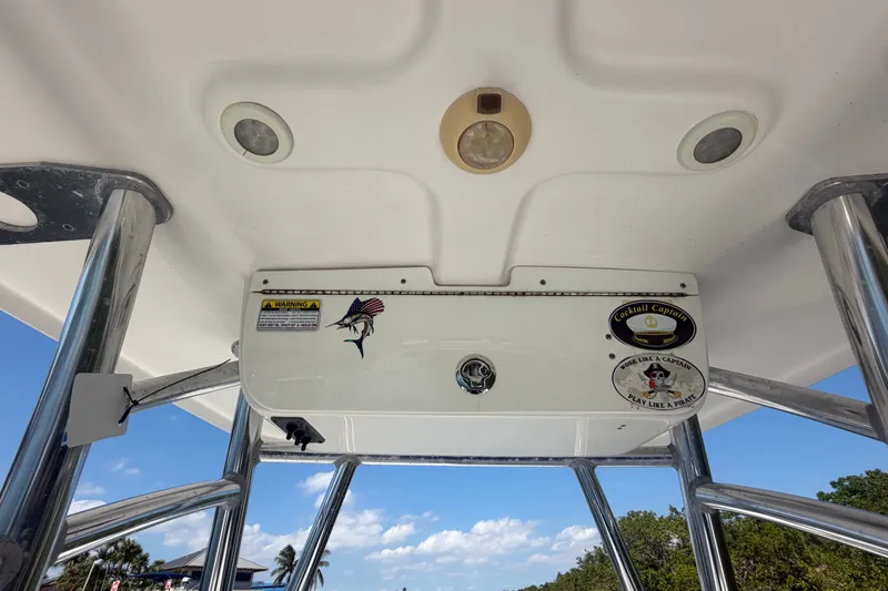 Slide: The Image of 2013 Sportsman Heritage 229 Center Console boat roof with decals and lighting fixtures. - 24