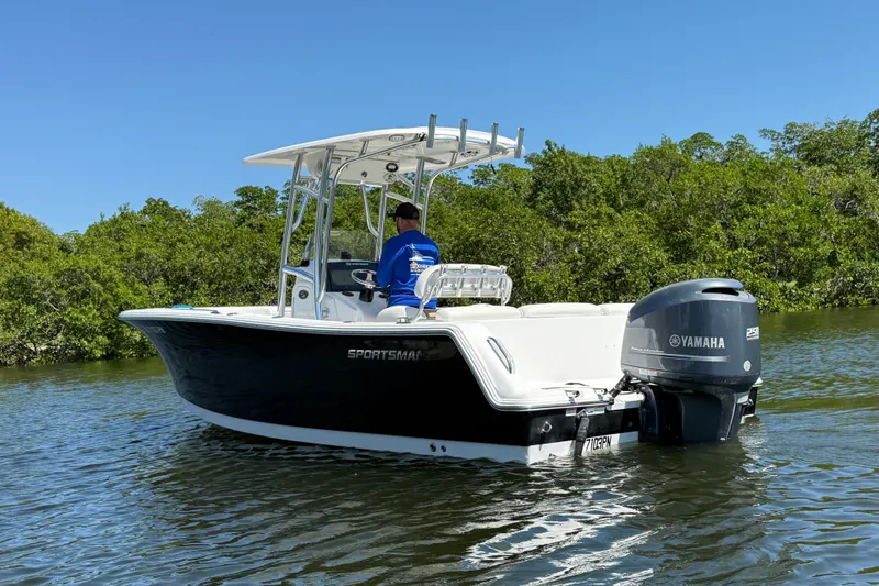 Slide: The Image of 2013 Sportsman Heritage 229 Center Console boat on water, featuring Yamaha engine. - 4