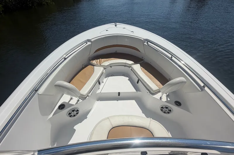 Slide: The Image of 2013 Sportsman Heritage 229 Center Console boat interior with cushioned seating and speakers. - 9