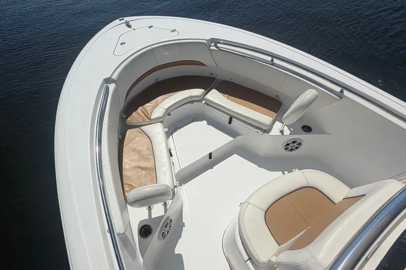 Slide: The Image of 2013 Sportsman Heritage 229 Center Console boat interior with cushioned seating and cup holders. - 8