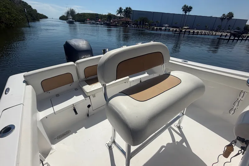 Slide: The Image of 2013 Sportsman Heritage 229 Center Console boat on calm waterway, featuring comfortable seating. - 20