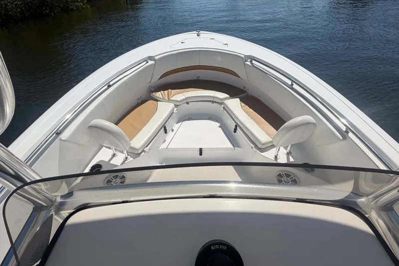 Slide: The Image of 2013 Sportsman Heritage 229 Center Console boat interior with cushioned seating and water view. - 7