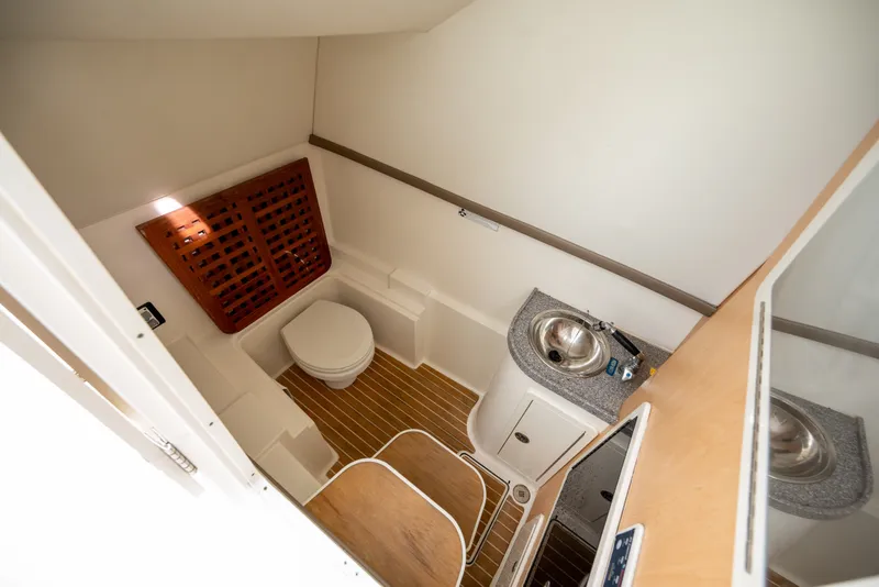 Slide: The Image of Interior of 2020 World Cat 320 DC boat bathroom with toilet and sink. - 14