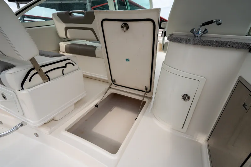 Slide: The Image of 2020 World Cat 320 DC interior with open storage compartment and sink area. - 21