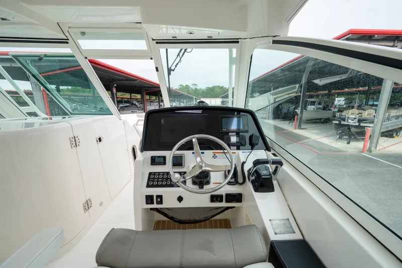 Slide: The Image of Cockpit of 2020 World Cat 320 DC boat with modern controls and steering wheel. - 7