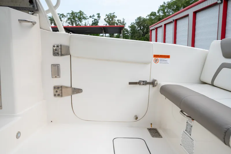 Slide: The Image of Interior view of a 2020 World Cat 320 DC boat, featuring seating and storage compartments. - 22