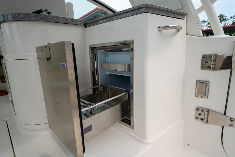 Slide: The Image of 2020 World Cat 320 DC boat with open stainless steel drawer refrigerator. - 15