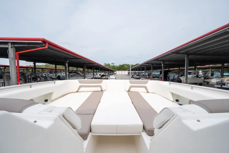 Slide: The Image of 2020 World Cat 320 DC boat interior with spacious seating at a marina. - 11