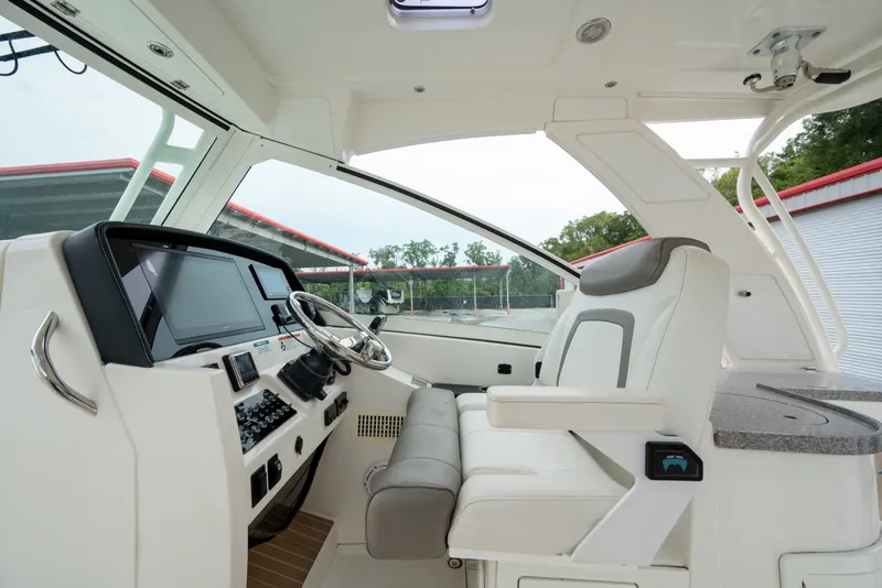 Slide: The Image of Interior view of 2020 World Cat 320 DC boat cockpit with modern controls and seating. - 9