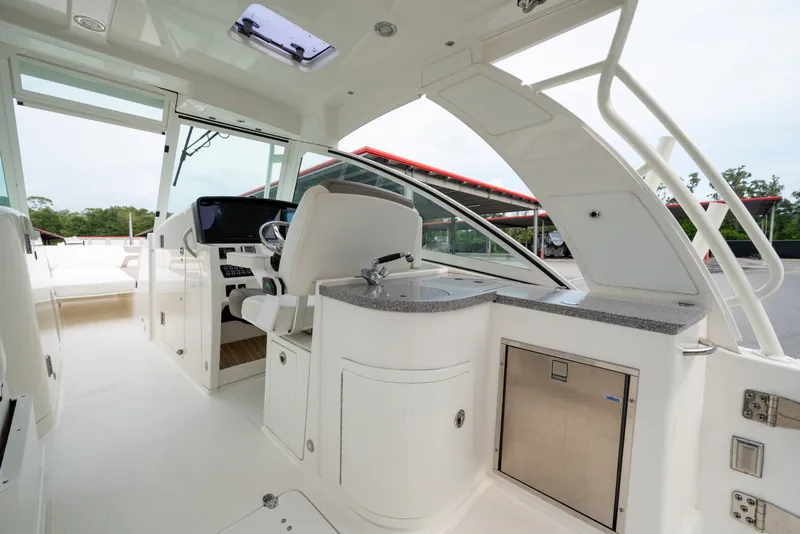 Slide: The Image of Interior of 2020 World Cat 320 DC boat, featuring helm and seating area. - 8