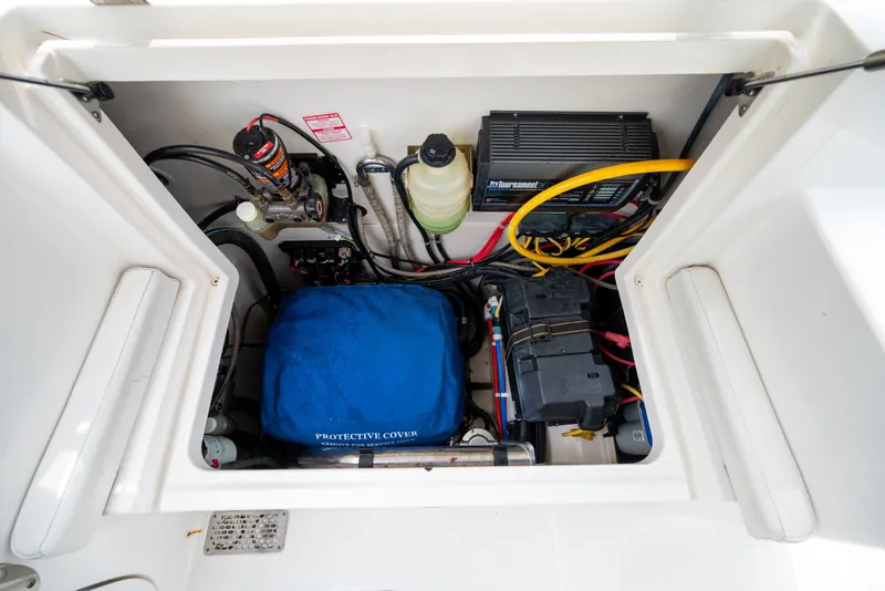 Slide: The Image of Engine compartment of a 2020 World Cat 320 DC boat, showcasing various components and wiring. - 20
