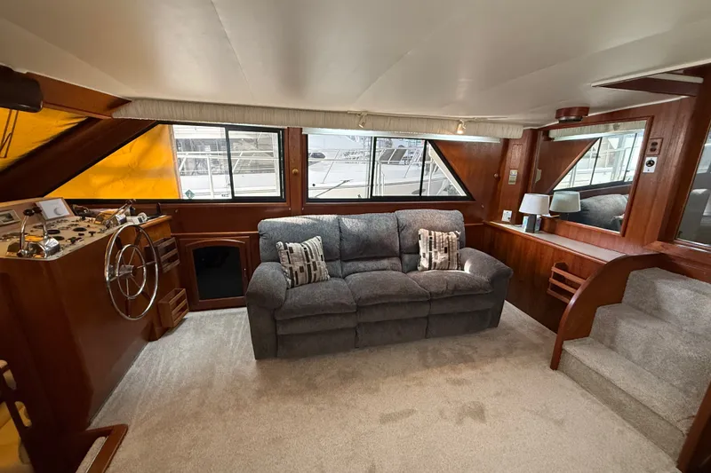 Slide: The Image of Interior of a 1988 Californian 45 Motor Yacht with plush seating and wooden accents. - 17