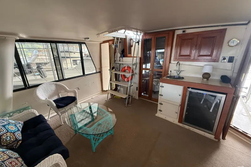 Slide: The Image of Interior of 1988 Californian 45 Motor Yacht with seating, kitchenette, and large windows. - 4