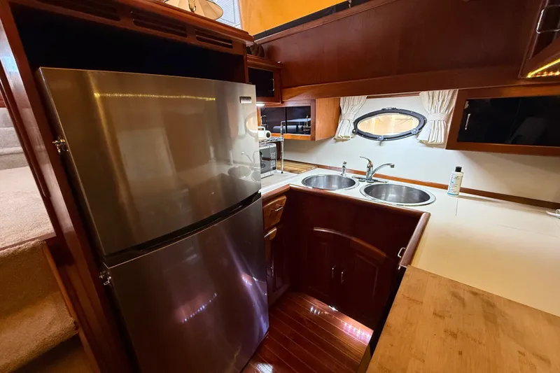 Slide: The Image of Galley kitchen in 1988 Californian 45 Motor Yacht with stainless steel fridge and dual sinks. - 20