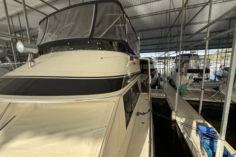 Slide: The Image of 1988 Californian 45 Motor Yacht docked in a covered marina. - 10