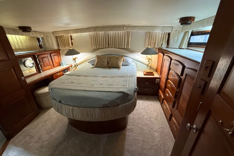 Slide: The Image of Luxurious bedroom interior of 1988 Californian 45 Motor Yacht with elegant wood furnishings. - 26
