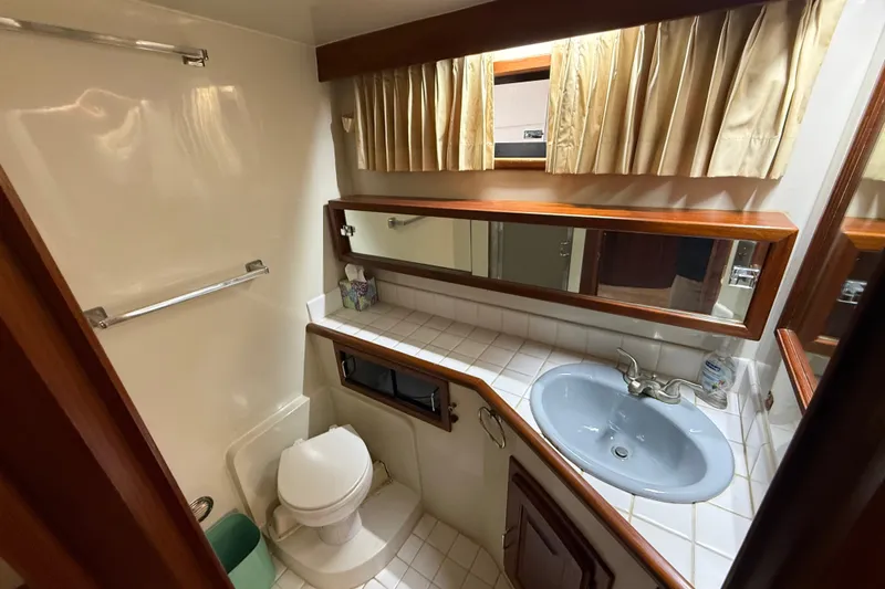 Slide: The Image of Bathroom interior of 1988 Californian 45 Motor Yacht with sink, toilet, and mirror. - 28