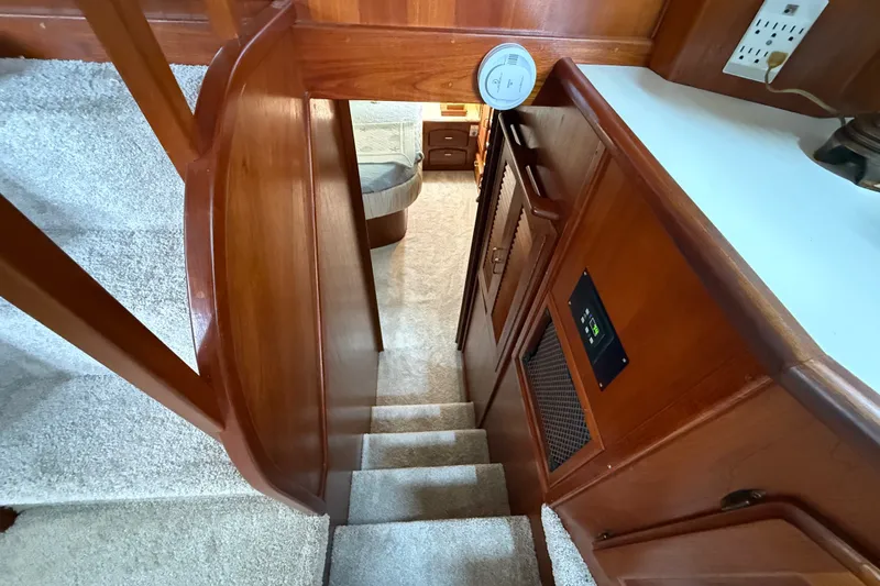 Slide: The Image of Interior view of 1988 Californian 45 Motor Yacht with wooden stairs and carpeted flooring. - 29