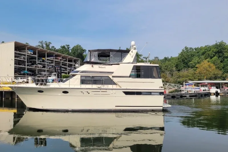 Slide: The Image of 1988 Californian 45 Motor Yacht docked at a marina, reflecting on calm water. - 3
