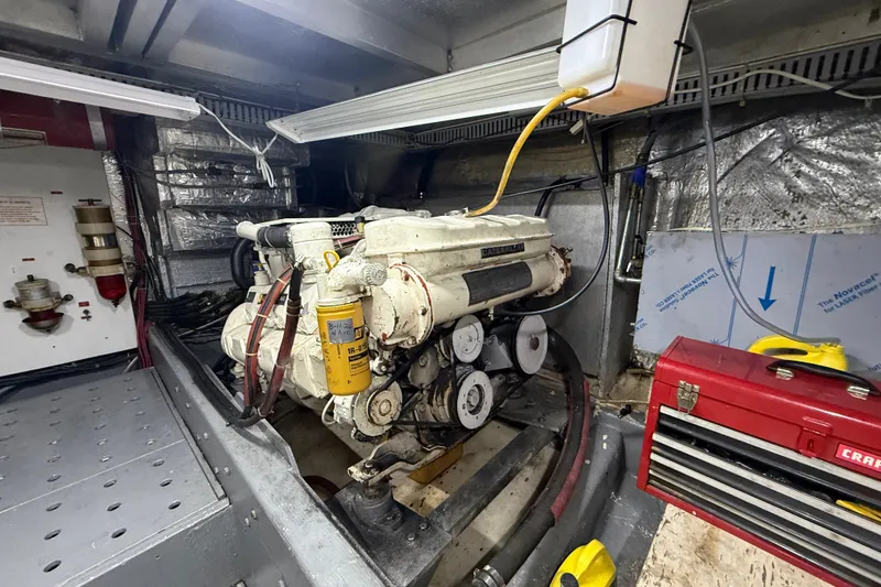 Slide: The Image of Engine room of a 1988 Californian 45 Motor Yacht with visible machinery and tools. - 32